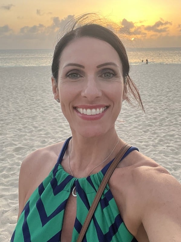Shannon, founder of The BRAVE Standard, smiling on the beach